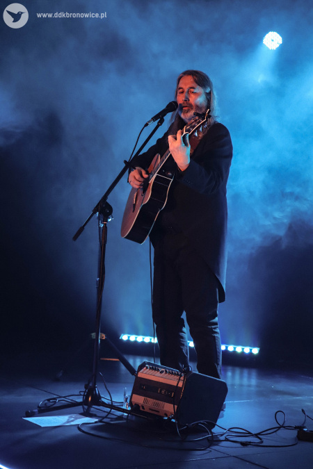 Na scenie niebieskie światło. Unosi się dym. Na scenie śpiewa i gra wzruszający utwór.